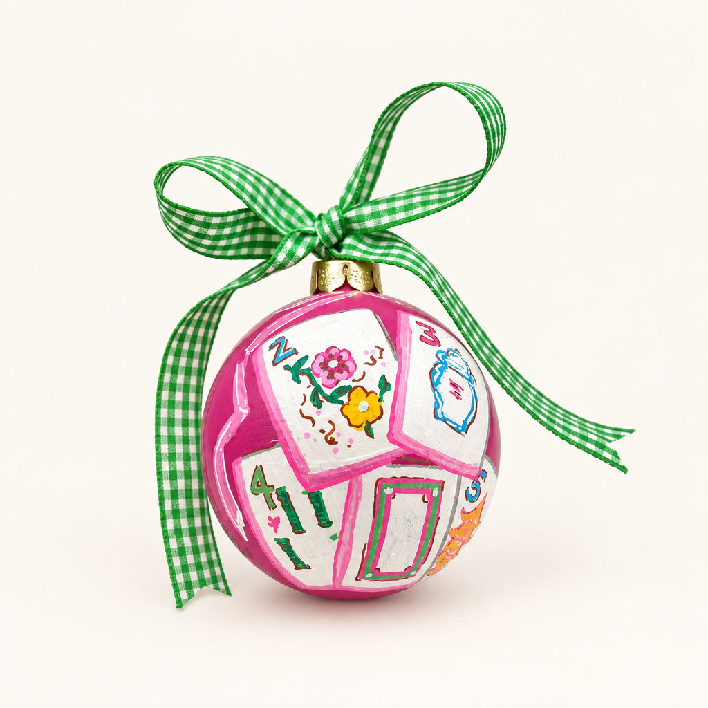 Girly Pop Mahjong ornament with a green gingham bow on a warm-white background